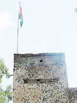 Bullet marks seen on the wall of an Indian post