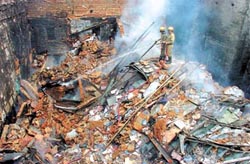 Firemen try to douse a blaze that engulfed a building of Gandhi Market at Sader Bazar