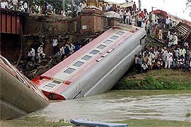 Indians crowd near the submerged coach