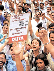 Teachers, students and karamcharis of Delhi University stage a dharna in front of the UGC office 