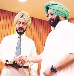 Punjab Chief Minister Amarinder Singh congratulates the new PPSC Chairman, Lt-Gen Surjit Singh Sangra (retd)