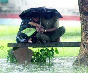A couple enjoys the downpour at Boat Club