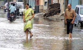 Residents of Adarsh Nagar in North Delhi wading through the ankle-deep water
