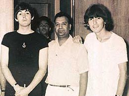 Paul McCartney and George Harrison with Bishan at his shop in 1966