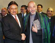 Pakistani President Pervez Musharraf, left, and Afghan President Hamid Karzai greet each other