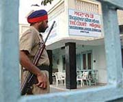 An armed policeman stands guard