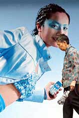 An elderly woman walks past a mobile phone advertisement
