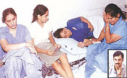 Grieving relatives of Satinder Prashar who died in the PGI on Monday; and (inset) the victim.