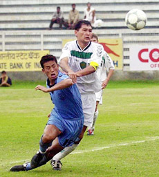 Indian soccer star and captain Baichung Bhutia attempts a goal