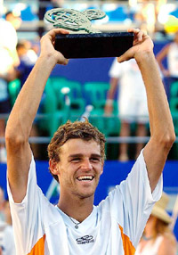 Brazilian tennis player Gustavo Kuerten holds the Brazil Open trophy
