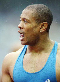 Maurice Green of the USA looks at the scoreboard to check his time after the men's 100 metre final