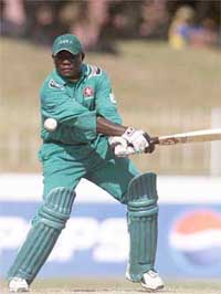 Kenyas captain Steve Tikolo drives a delivery to the fence