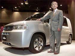Honda Motor Corp. Ltd president Hiroyuki Yoshino stands beside Honda's new Mobilio Spike