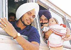 An employee consoles his crying daughter while leaving for poll duty in Jammu and Kashmir from Ludhiana 