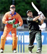 Pakistans Shahid Afridi hits a six as the Netherlands wicketkeeper Reinout Scholte looks on 