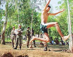 A candidate clears an obstacle during an Army recruitment camp