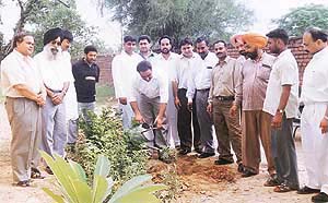 The president of the Lions Club, Samrala, Mr Deepak Verma, plants a sapling
