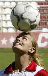 Brazilian Milene Domingues, wife of Real Madrids star Ronaldo, heads the ball during her presentation at Teresa Rivero stadium in Madrid