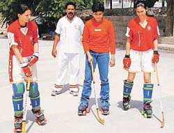 Raysha Rajput, Anuja Chauhan and Ritika Sharma, members of the Indian roller hockey team, get tips from coach Balwinder Singh