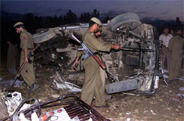 Policemen examine the wreckage
