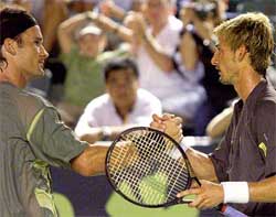 Spanish compatriots Juan Carlos Ferrero and Carlos Moya shake hands