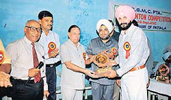 Former cricketer Navjot Singh Sidhu being honoured by Mr J.R. Devgan, General Manager, State Bank of Patiala, at a function in Patiala on Sunday.
