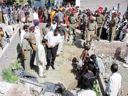 SP Naunihal Singh inspects the site where the body of Harnek Singh was dumped by the accused