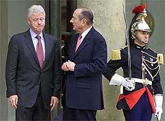 Former US President Bill Clinton, grimaces as he leaves the Elysee Palace