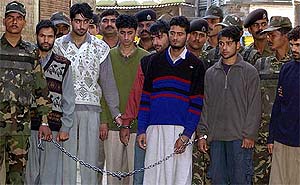 BSF personnel escort a group of seven militants