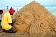 Sudarshan Patnaik, a sand artist, creates a sculpture of the Hindu Goddess Durga
