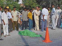 The body of Saroj lies on road after she was run over by a truck