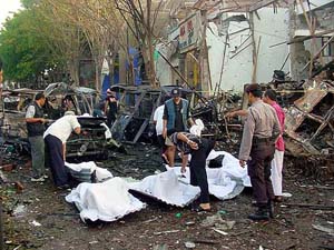 Indonesian policemen check bodies