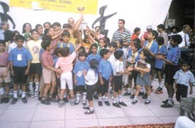 Schoolchildren with their roller skate prizes