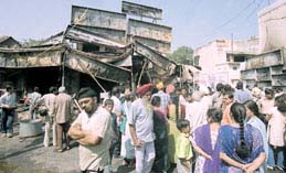 Anxious onlookers in the Sector 8 market, where a fire broke out in a cracker shop