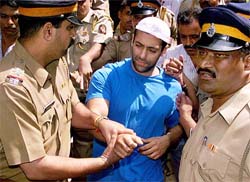 Film star Salman Khan is escorted by the police to a court in Mumbai