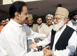Vice-President of the Muttahida Majlis-e-Amal Qazi Hussain Ahmed, an alliance of six hardline Islamic parties, greets Makhdoom Amin Fahim of the PPPP in Islamabad on Monday.