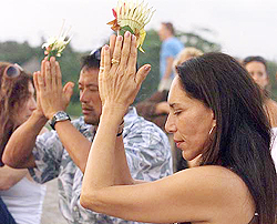 Westerners pray in traditional Balinese styleto victims of a bomb blast during a vigil on a beach near Kuta on Monday. 