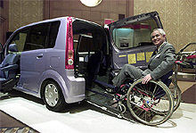 Daihatsu Motor Co President Takaya Yamada sits in a wheelchair