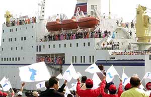 North Koreans wave from the Mankyongbong ship