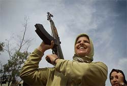 An Iraqi woman holds gun as she celebrates referendum results
