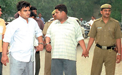 Sandeep Malik and Kishen Gogia, who the police claim were arrested after a fierce encounter in Nazafgarh last night. 