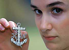 Sotheby's employee Lindsay Drewett holds up the brooch