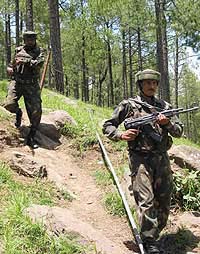 Armymen patrol on the Line of Control