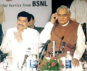 Prime Minister Atal Behari Vajpayee talks over a cellphone with Mr L. K. Advani in New Delhi 