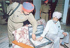 Vigilance officials seen with the recovered currency notes.