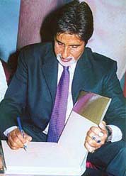Signature style: the man with the inimitable style autographs the book on him