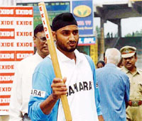 Harbhajan Singh carries a stump as a souvenir