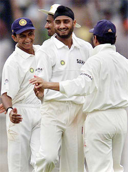 Harbhajan Singh celebrates with team-mate Sachin Tendulkar (R), Sanjay Bangar (L) and Anil Kumble after taking the wicket of Ryan Hinds during the fourth day of the second Test