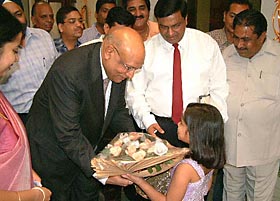 A student of Apeejay School presents a bouquet to Lord Swraj Paul