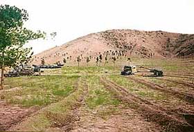 Tanks and anti-aircraft guns stand guard near the mined Kabul golf course